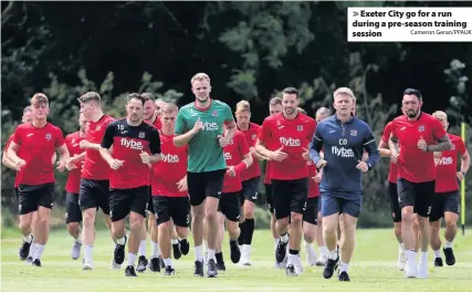  ?? Cameron Geran/PPAUK ?? > Exeter City go for a run during a pre-season training session