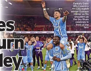 ?? ?? Fankaty Dabo lifts Coventry City match winner Gustavo Hamer on his shoulders as the Sky Blues celebrate in front of the fans