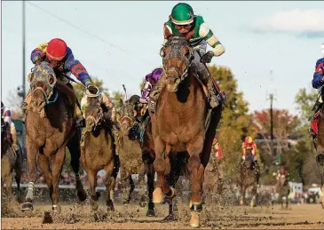  ?? ANDY LYONS / GETTY IMAGES ?? Joel Rosario rides Accelerate to victory in the Breeders’ Cup Classic on Saturday at Churchill Downs. Accelerate won by a length, strengthen­ing his bid for horse of the year honors.