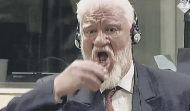  ?? PICTURE; GETTY IMAGES ?? 0 Slobodan Praljak swallows what was believed to be poison after judges in The Hague confirmed his 20-year sentence for war crimes