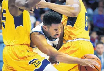  ?? LAURENCE KESTERSON/ASSOCIATED PRESS ?? Villanova guard Phil Booth works his way between La Salle’s Tony Washington (5) and Pookie Powell during a win Sunday. The Wildcats climbed into the No. 1 spot in this week’s AP Top 25.