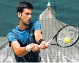  ?? CLIVE BRUNSKILL/GETTY ?? Novak Djokovic practices for his title defense at Wimbledon, where he will be aiming for his 16th Grand Slam title.