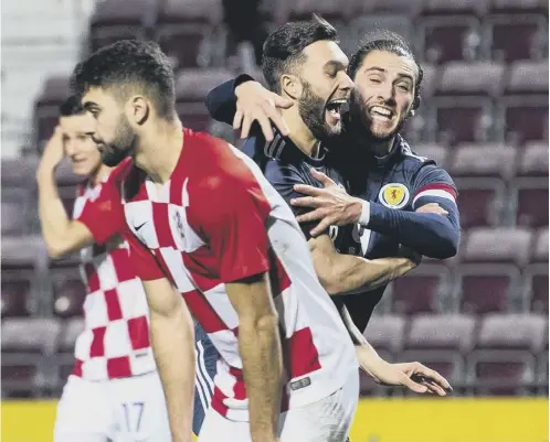  ??  ?? 0 Scotland substitute Connor Mclennan celebrates with Fraser Hornby after making it 2-2 against Croatia at Tynecastle Park.