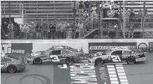  ?? THE ASSOCIATED PRESS ?? Austin Dillon leads Daniel Hemric to the checkered flag behind the pace car while under caution during the NASCAR Xfinity series race on Saturday in Brooklyn, Mich.