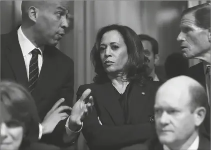  ?? ASSOCIATED PRESS FILE PHOTO ?? SENATE JUDICIARY COMMITTEE MEMBERS SEN. CORY BOOKER, D.-N.J., top left, Sen. Kamala Harris, D-Calif., and Sen Richard Blumenthal, D-Conn., right, talk in 2018 as Sen. Jeff Flake, R-Ariz., discusses his concerns before the committee on Capitol Hill in Washington. Sen. Amy Klobuchar, D-Minn. and Sen. Chris Coons, D-Del., are seated. Fifty years after she was part of the second class to integrate Berkeley’s public schools, Harris is now the first Black woman and first Asian American woman named to a major party presidenti­al ticket.