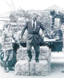  ?? Photo / Lincoln College ?? Prince Philip steps down from a tractor after a journey aboard a bale of hay during a visit to Lincoln Collegein 1973, with Roy Day (left) Alistair Mackintosh [top right] and Wayne Carlton