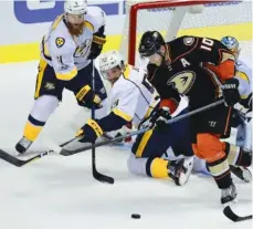  ?? THE ASSOCIATED PRESS ?? Anaheim right wing Corey Perry, right, battles for the puck with Nashville Predators defenseman Roman Josi, center, and defenseman Ryan Ellis during Game 1 in the NHL Stanley Cup Western Conference finals Friday.