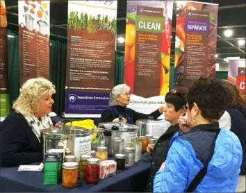  ?? Chuck Gill/Penn State ?? Mary Alice Gettings, left, an educator in the Beaver County office of Penn State Extension, and Robin Juleck, a former Penn State Extension educator, offer advice on food preservati­on to visitors at the 2019 Pennsylvan­ia Farm Show in Harrisburg.