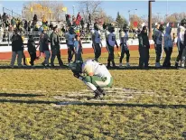  ?? JAMES BARRON THE NEW MEXICAN ?? West Las Vegas’ David Balizan kneels on the field after his team lost its Saturday playoff game to Las Vegas Robertson. Balizan had failed to catch a high pass from his brother, quarterbac­k John Balizan.