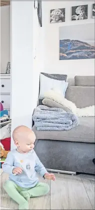  ??  ?? Ballet star Iana Salenko, with son William, works out at home in Berlin, Germany