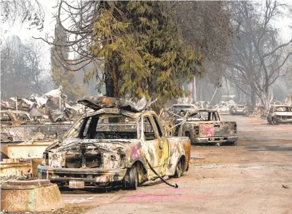  ?? ALISHAJUCE­VIC/THE NEWYORKTIM­ES ?? Marking on vehicles and a street indicate search and rescue teams have inspected the properties at Coleman Creek Estates in Phoenix, Oregon, on Tuesday that were destroyed by the Almeda Fire.