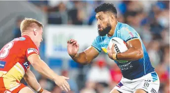  ?? ?? Gold Coast’s Isaac Liu runs the ball against the Dolphins Picture: Getty Images