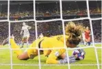  ?? RICHARD HEATHCOTE/GETTY PHOTOS ?? U.S. goalkeeper Alyssa Naeher lunges to make a save on a penalty kick in the 84th minute in a 2-1 win over England on Tuesday.