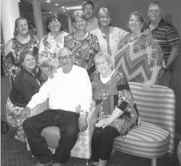  ?? Staff photo by Greg Bischof ?? ■ Troy Wayne Buck, a retired vocational and agricultur­al teacher for the Hope Public School System, sits with his wife, Wilma, while surrounded by his six daughters at the system’s Friday afternoon Educator Hall of Fame induction and celebratio­n. Of the five inductees, Buck is the only one still living. His daughters, starting at his right arm and circling around to his left, are Kalena Gay Hughes, Tralena Kay Buck, Chewnerhea Buck, Waulea Skeeter Huckabee, Neeka Richardson and Sandy Jester.