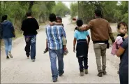  ?? AP PHOTO/ERIC GAY, FILE ?? A group of migrant families walk from the Rio Grande, the river separating the U.S. and Mexico in Texas, near McAllen, Texas, March 14, 2019.