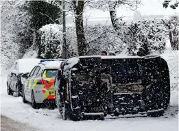  ??  ?? Worlds apart: An overturned car in Wakefield yesterday