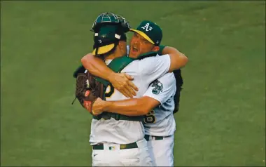  ?? JOSE CARLOS FAJARDO — STAFF PHOTOGRAPH­ER ?? A’s pitcher Liam Hendriks, right, celebrates with catcher Sean Murphy after the final out of Thursday’s Wild Card Series victory.