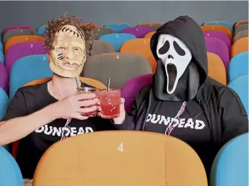  ?? ?? CHEERS FOR FEARS: Horror icons Leatherfac­e and Ghostface try Candyman cocktails.