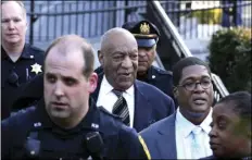  ?? AP PHOTO/MEL EVANS ?? Bill Cosby (center) leaves hearings for jury selection in his sexual assault retrial with spokespers­on Andrew Wyatt (second right) at the Montgomery County Courthouse in Norristown, Pa.