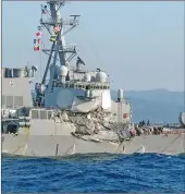  ?? Associated Press photos ?? LEFT: The USS Fitzgerald is seen off Izu Peninsula in, Japan, after the Navy destroyer collided Saturday with a merchant ship. BELOW: The damage of Philippine-registered container ship ACX Crystal is seen off Izu Oshima, Japan, after it had collided...