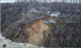  ?? MELVIN MARTIN — HARDIN COUNTY FIRE DEPARTMENT, SAVANNAH, TENN., VIA AP ?? A landslide on Chalk Bluff on the Tennessee River causes damage. Authoritie­s say two homes were destroyed when the hillside collapsed near the swollen river.