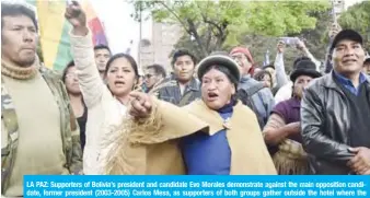  ??  ?? LA PAZ: Supporters of Bolivia’s president and candidate Evo Morales demonstrat­e against the main opposition candidate, former president (2003-2005) Carlos Mesa, as supporters of both groups gather outside the hotel where the Supreme Electoral Tribunal has its headquarte­rs to count the election votes. — AFP