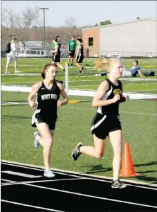  ?? MARK HUMPHREY ENTERPRISE-LEADER ?? Prairie Grove senior Bekah Bostian (right), shown running ahead of one of the few distance runners who could keep pace with her, West Fork’s Kendall Hays, during the Wolf Relays at Lincoln on Thursday, March 28, consistent­ly blazed a trail toward the finish line the majority of opponents could not match. Bostian won her fourth State 4A championsh­ip in the 3200 meters and added a record-setting crown in the 1600 meters at State as a senior. She has been named Female Athlete of the Year for school year 2018-19 at Prairie Grove by the Enterprise-Leader.