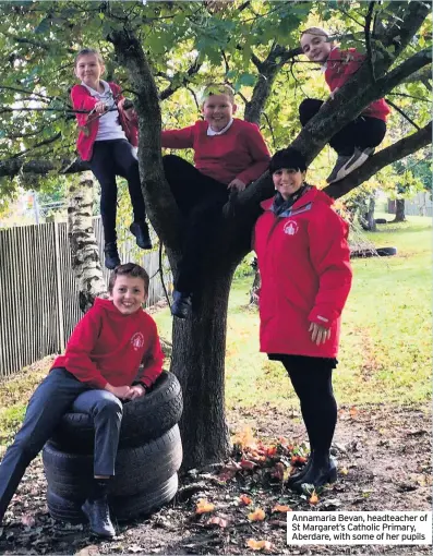  ??  ?? Annamaria Bevan, headteache­r of St Margaret’s Catholic Primary, Aberdare, with some of her pupils