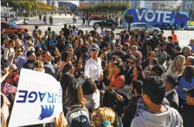  ?? Gabrielle Lurie / The Chronicle ?? Gubernator­ial candidate Gavin Newsom signs autographs in front of San Francisco City Hall Tuesday, with his campaign bus parked across the street.