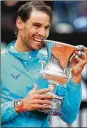  ?? CLIVE BRUNSKILL / GETTY IMAGES ?? Rafael Nadal of Spain celebrates with his trophy after his three set victory against Novak Djokovic of Serbia in the men’s final during day eight of the Internatio­nal BNL d’Italia at Foro Italico on Sunday in Rome.