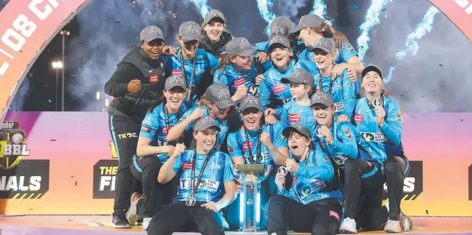  ?? Picture: Mark Kolbe/Getty Images ?? The Adelaide Strikers celebrate with the trophy after victory in the Women's Big Bash League Final against the Sixers in Sydney.