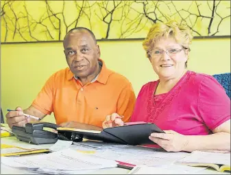  ?? SUEANN MUSICK/THE NEWS ?? NDP campaign office manager Vera Lynn MacNeil goes over a volunteer list with Pictou Centre NDP candidate Henderson Paris at his campaign office.