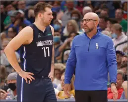  ?? RON JENKINS/GETTY IMAGES ?? In this photo from Oct. 26, 2021, Luka Doncic (77) of the Dallas Mavericks talks with head coach Jason Kidd in Dallas.