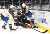  ?? Alex Gallardo Associated Press ?? THE DUCKS’ Jani Hakanpaa, center, battles the Avalanche’s Matt Calvert (11) and Valeri Nichushkin.