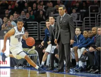  ?? DFM FILE ?? Villanova’s Phil Booth drives down the court past head coach Jay Wright during a game in March 2015. The guard missed all but three games of the 2016 season with a knee injury but is an important returning piece in a reloaded Wildcats squad.