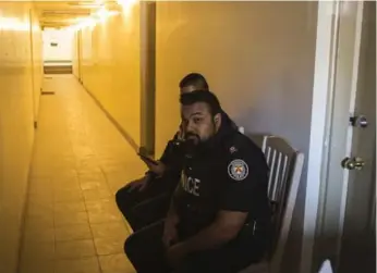  ?? CHRIS YOUNG/THE CANADIAN PRESS ?? Toronto Police officers sit outside Ayanle Hassan Ali’s residence in Etobicoke on Tuesday.