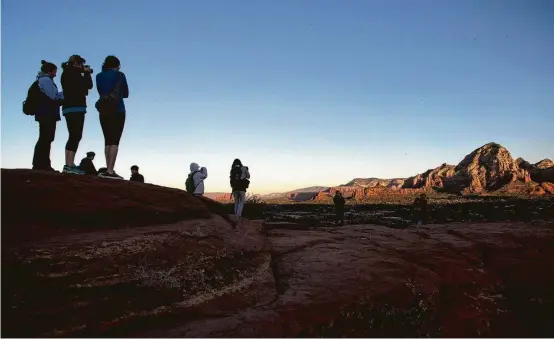  ?? Jon Shapley / Houston Chronicle ?? The sun rise lights Capital Butte at Airport Mesa. The mesa is also said to be a vortex, or a place where visitors say the Earth's energy is especially conducive to spiritual and physical healing.