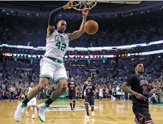  ?? — AP ?? Boston Celtics’ Al Horford (left) slams a dunk against the Chicago Bulls in Boston on Wednesday.