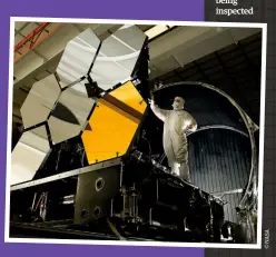  ??  ?? Below: The primary mirror segment of the James Webb Space Telescope being inspected