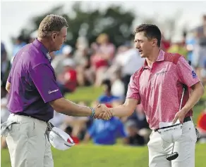  ?? MINAS PANAGIOTAK­IS/GETTY IMAGES ?? Ernie Els, left, played alongside MacKenzie Hughes of Hamilton for the first two days of the RBC Canadian Open, and while Els missed the cut, Hughes sits in a tie for 14th.