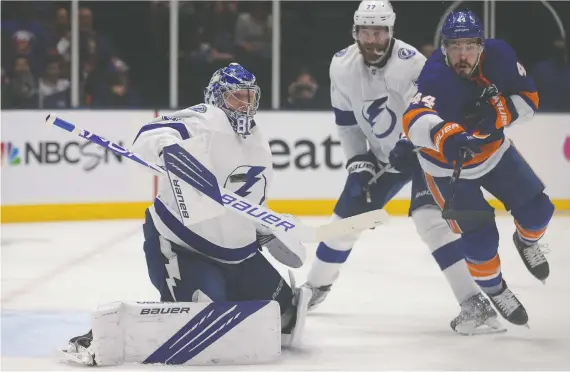  ?? BRAD PENNER/USA TODAY SPORTS ?? Islanders centre Jean-gabriel Pageau attempts to tip the puck past Lightning goalie Andrei Vasilevski­y, who was particular­ly sharp in Tampa's Game 3 win.