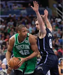  ?? AP PHOTO ?? BIG IS BACK: Al Horford looks to pass the ball around Mario Hezonja last night in Orlando, Fla.