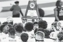  ?? Brett Coomer / Staff photograph­er ?? Katy’s football team celebrates its 51-14 win over Cedar Hill to capture the Class 6A Division II state championsh­ip in January.