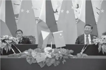  ?? ASSOCIATED PRESS ?? President Rodrigo Duterte, left, and Chinese President Xi Jinping attend a signing ceremony in Beijing, China.