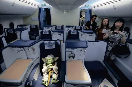  ?? Themed
Star WarsPICTUR­E: REUTERS ?? MARKETING FRENZY: Visitors encounter a Yoda plush toy in the business class section during a tour of the
All Nippon Airways ANA R2-D2 Boeing 787 Dreamliner aircraft at Singapore’s Changi Airport.