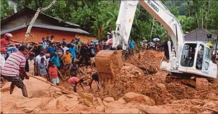  ?? AFP PIC ?? Rescue workers and villagers searching for survivors at the site of a mudslide in Bellana village in Kalutara, Sri Lanka, yesterday. Heavy monsoon rains triggered flooding and landslides that killed at least 91 people and left another 110 missing,...