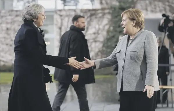  ??  ?? Theresa May meets Angela Merkel before heading to a meeting in the chanceller­y in Berlin during her trip to Europe in a bid to win concession­s from the EU