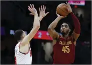  ?? (AP/Ron Schwane) ?? Cleveland Cavaliers guard Donovan Mitchell (right) attempts a shot as Chicago Bulls guard Zach LaVine defends in the second half Monday in Cleveland. Mitchell scored 71 points in the Cavaliers’ 145-134 win in overtime.