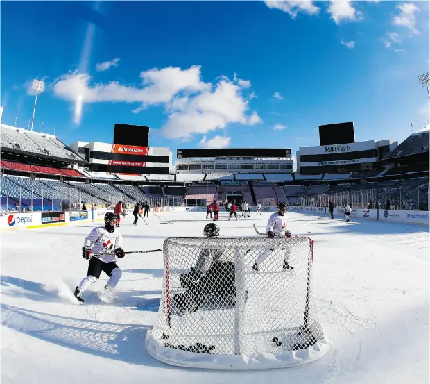  ?? MARK BLINCH / THE CANADIAN PRESS ?? Team Canada players take the ice at an outdoor practice at New Era Field in Orchard Park, N.Y., on Thursday.