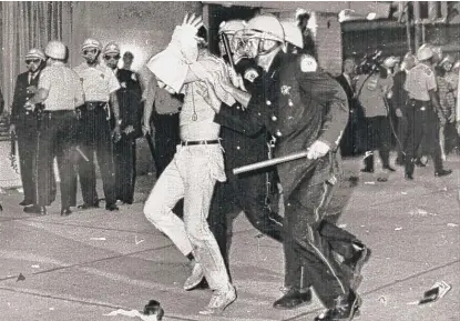  ?? AP ?? Chicago police lead away a demonstrat­or on Michigan Avenue on Aug. 28, 1968, near the Conrad Hilton Hotel.